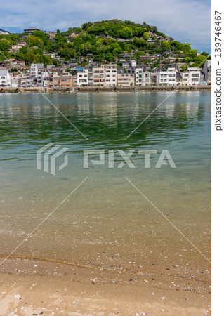 The cityscape of Onomichi and the sandy beach as seen from Mukaijima Island, a view of the Shimanami Kaido. 139746467