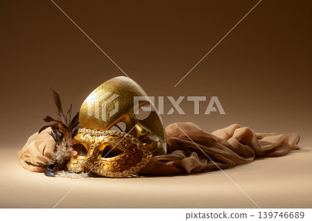 Golden Venetian carnival masks on a beige background. 139746689