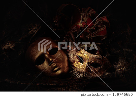 Golden carnival masks on a dark background. Golden carnival masks on a dark background. 139746690