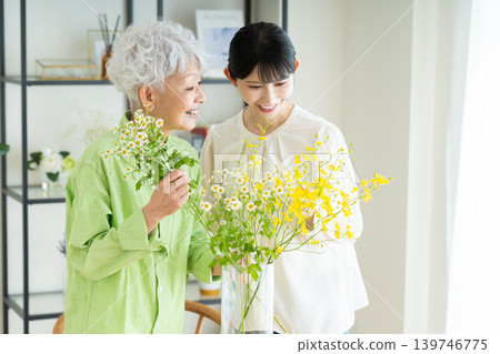 Senior parent and child arranging flowers Senior parent and child arranging flowers 139746775