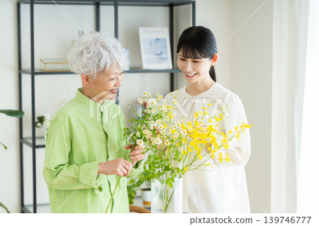 Senior parent and child arranging flowers Senior parent and child arranging flowers 139746777