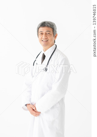 Medical man in a white coat with a stethoscope Medical man in a white coat with a stethoscope 139746815