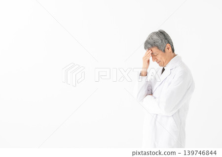 Medical white coat man thinking Medical white coat man thinking 139746844
