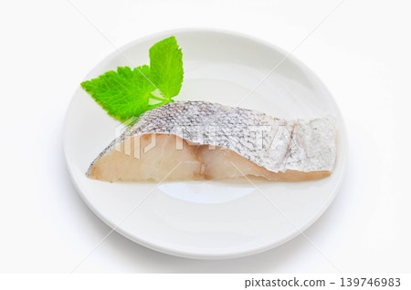 Raw cod fillets on a white plate. Raw cod fillets on a white plate. 139746983