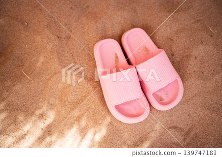 Pink beach slippers on sandy shore at Red Sea resort in Sharm El Sheikh Egypt during summer vacation. Travel and beach lifestyle Pink beach slippers on sandy shore at Red Sea resort in Sharm El Sheikh Egypt during summer vacation. Travel and beach lifestyle 139747181