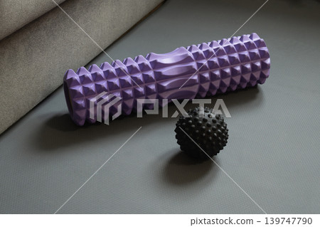 Massage roller and ball on fitness mat 139747790
