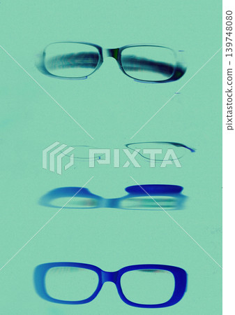 Stylish eyeglasses photogram with vintage film scratches, experimental optical composition, blue cyan negative aesthetic, retro scanography background with blurred glasses frames. Turquoise background Stylish eyeglasses photogram with vintage film scratches, experimental optical composition, blue cyan negative aesthetic, retro scanography background with blurred glasses frames. Turquoise background 139748080
