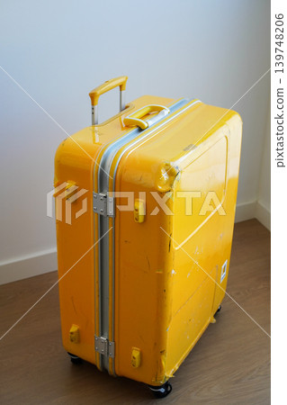 A hard-shell yellow carry-on bag that was damaged during travel. A hard-shell yellow carry-on bag that was damaged during travel. 139748206