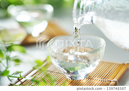 夏日里,將冰鎮清酒倒入清酒杯中(圖) 夏日里,將冰鎮清酒倒入清酒杯中(圖) 139748387