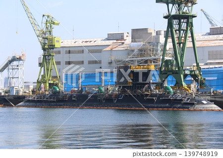 A submarine undergoing routine inspection (overhaul) at Kawasaki Heavy Industries' Kobe Plant, Dock No. 4. A submarine undergoing routine inspection (overhaul) at Kawasaki Heavy Industries' Kobe Plant, Dock No. 4. 139748919