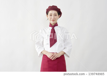 Female pastry chef/baker/cafe employee, portrait, looking at the camera, white background. Female pastry chef/baker/cafe employee, portrait, looking at the camera, white background. 139748985