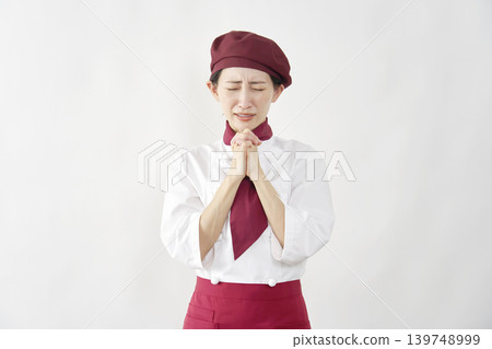 Female pastry chef/baker/cafe employee pleading, white background. Female pastry chef/baker/cafe employee pleading, white background. 139748999