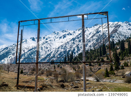 Empty billboard frame structure on mountain background with snow capped peaks Empty billboard frame structure on mountain background with snow capped peaks 139749091