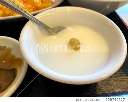 Almond tofu in a white bowl with a spoon - Chinese dessert Almond tofu in a white bowl with a spoon - Chinese dessert 139749317