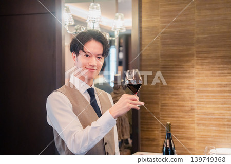 A male sommelier checking the wine A male sommelier checking the wine 139749368