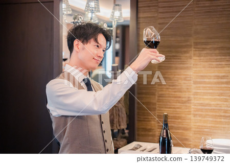 A male sommelier checking the wine A male sommelier checking the wine 139749372