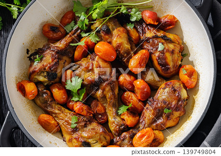 Roasted chicken drumsticks with tomatoes in a pot Roasted chicken drumsticks with tomatoes in a pot 139749804