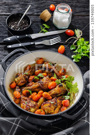 Roasted chicken drumsticks with tomatoes in a pot Roasted chicken drumsticks with tomatoes in a pot 139749805