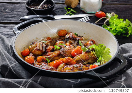 Roasted chicken drumsticks with tomatoes in a pot 139749807