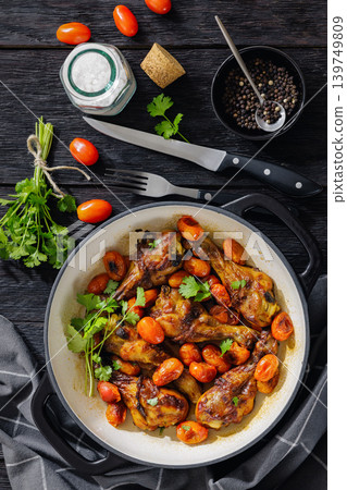 Roasted chicken drumsticks with tomatoes in a pot Roasted chicken drumsticks with tomatoes in a pot 139749809