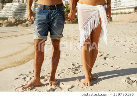 Love, holding hands and closeup of couple at a beach for walking, romance and bonding in nature together. Summer, zoom and legs or people at sea for travel, holiday or vacation with support or trust Love, holding hands and closeup of couple at a beach for walking, romance and bonding in nature together. Summer, zoom and legs or people at sea for travel, holiday or vacation with support or trust 139750186
