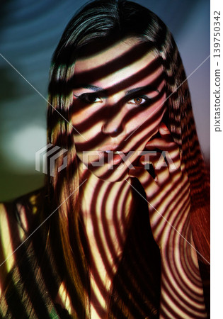 Woman, art and portrait with creative, light and pattern projection with cosmetics and beauty. Shadow, confidence and female model with makeup, glow and spotlight with retro fantasy in studio Woman, art and portrait with creative, light and pattern projection with cosmetics and beauty. Shadow, confidence and female model with makeup, glow and spotlight with retro fantasy in studio 139750342