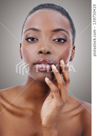 Beauty, portrait and black woman with makeup and skincare in studio, background or salon. Nails, facial and African model with healthy natural glow on skin and hand from cosmetics or dermatology Beauty, portrait and black woman with makeup and skincare in studio, background or salon. Nails, facial and African model with healthy natural glow on skin and hand from cosmetics or dermatology 139750419