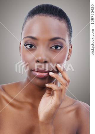 Skincare, portrait and black woman with beauty and confidence in studio, background or salon. Nails, makeup and serious model with healthy natural glow on skin from cosmetics, facial or dermatology Skincare, portrait and black woman with beauty and confidence in studio, background or salon. Nails, makeup and serious model with healthy natural glow on skin from cosmetics, facial or dermatology 139750420