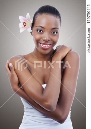 Portrait, beauty and flower with self love black woman in studio on gray background for natural skincare. Smile, hug and orchid with happy young model at spa for aesthetic wellness or cosmetics Portrait, beauty and flower with self love black woman in studio on gray background for natural skincare. Smile, hug and orchid with happy young model at spa for aesthetic wellness or cosmetics 139750443