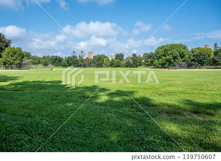 New york, usa august 18,2024. Central park north meadow baseball fields on a sunny summer day. Green lawns and trees with the manhattan skyline in background New york, usa august 18,2024. Central park north meadow baseball fields on a sunny summer day. Green lawns and trees with the manhattan skyline in background 139750607