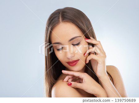 Beauty, cosmetics and woman in studio with makeup and face routine with red lipstick. Self care, nail polish and model with manicure and facial cosmetology treatment for glow by gray background. Beauty, cosmetics and woman in studio with makeup and face routine with red lipstick. Self care, nail polish and model with manicure and facial cosmetology treatment for glow by gray background. 139750689
