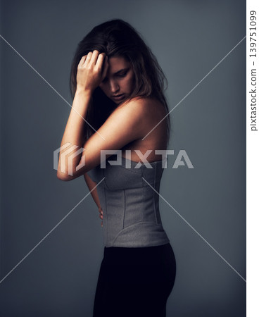 Fashion, thinking and woman on a grey background with serious style in a studio. Idea, vision and female person with dark backdrop in a cool, edgy clothing outfit confidence and cool or trendy pride Fashion, thinking and woman on a grey background with serious style in a studio. Idea, vision and female person with dark backdrop in a cool, edgy clothing outfit confidence and cool or trendy pride 139751099