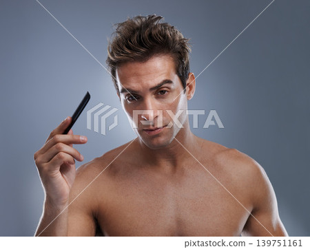 Man, portrait and comb hair for style or grooming on grey background for hygiene, self care and shirtless. Male person, model and face with brush for routine in morning, confidence or mockup space Man, portrait and comb hair for style or grooming on grey background for hygiene, self care and shirtless. Male person, model and face with brush for routine in morning, confidence or mockup space 139751161