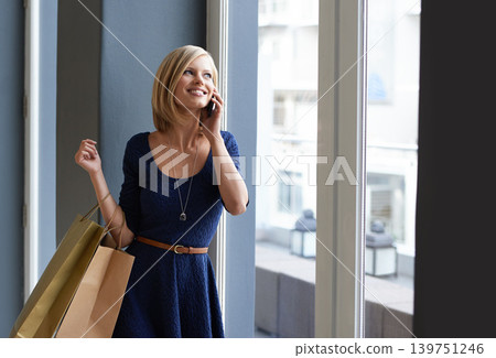 Happy, phone call and woman with shopping bags by window for communication in mall or boutique. Smile, cellphone and young female person with style on mobile conversation in retail store for fashion. Happy, phone call and woman with shopping bags by window for communication in mall or boutique. Smile, cellphone and young female person with style on mobile conversation in retail store for fashion. 139751246