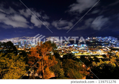 Panoramic night view of Medellín, Colombia, South America, with city lights shining against the Andes Mountains. Panoramic night view of Medellín, Colombia, South America, with city lights shining against the Andes Mountains. 139751276