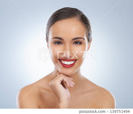 Happy, makeup and portrait of woman with red lipstick in studio with beauty, cosmetic and face routine. Self care, smile and female model with facial cosmetology treatment for glow by gray background Happy, makeup and portrait of woman with red lipstick in studio with beauty, cosmetic and face routine. Self care, smile and female model with facial cosmetology treatment for glow by gray background 139751494