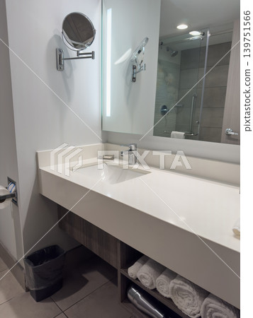 Modern bathroom with sink and mirror in a hotel room Modern bathroom with sink and mirror in a hotel room 139751566