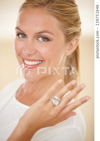 Woman, portrait and wedding ring with engagement announcement and diamond. Marriage, female person and showing hand with jewelry band, proposal and fiance with a smile and happy from commitment 139751646
