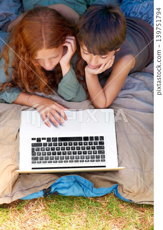 Children, internet and search with laptop in tent for camping, social media or movie with aerial view in nature. Family, online and siblings or browsing outdoor on grass for trip, relax and holiday Children, internet and search with laptop in tent for camping, social media or movie with aerial view in nature. Family, online and siblings or browsing outdoor on grass for trip, relax and holiday 139751794