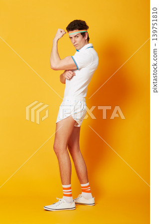 Portrait, tennis and man flexing arms with fitness and workout on a yellow background. Person, model and athlete in sportswear and training with confidence and proud with wellness and healthy Portrait, tennis and man flexing arms with fitness and workout on a yellow background. Person, model and athlete in sportswear and training with confidence and proud with wellness and healthy 139751810