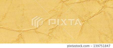 Light golden crumpled textured background from textile material. Wrinkled yellow fabric surface, macro Light golden crumpled textured background from textile material. Wrinkled yellow fabric surface, macro 139751847