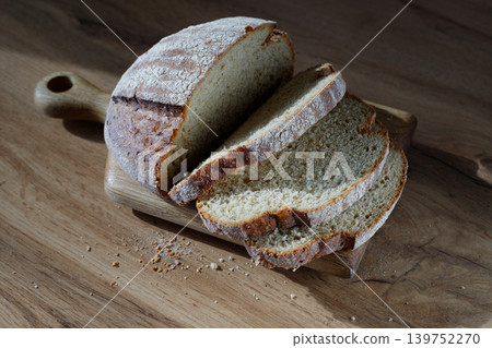 Whole grain bread into crispy slices for bruschetta. Fresh, crisp sourdough bread on the table. Whole grain bread into crispy slices for bruschetta. Fresh, crisp sourdough bread on the table. 139752270