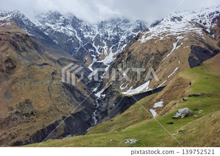 Snow-capped peaks rise above rugged valleys. Georgia Snow-capped peaks rise above rugged valleys. Georgia 139752521