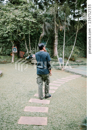 Southeast Asian Man Walking Outdoors While Looking Around Southeast Asian Man Walking Outdoors While Looking Around 139752555
