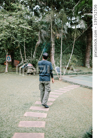 Asian Male Walking Away in Outdoor Environment Asian Male Walking Away in Outdoor Environment 139752556