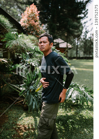 Asian Male Suffering from Stomach Pain Outdoors Asian Male Suffering from Stomach Pain Outdoors 139752575