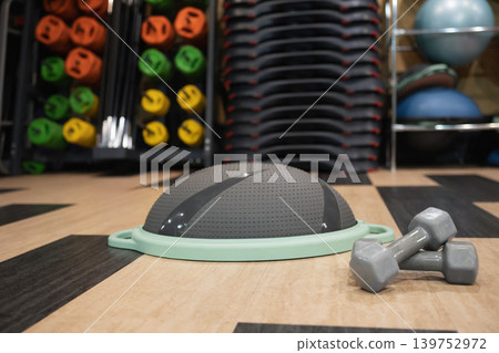 Balance trainer with dumbbells in modern gym interior Balance trainer with dumbbells in modern gym interior 139752972