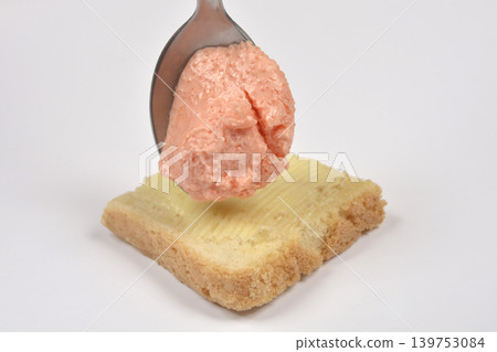 Salmon and fish roe spread on a spoon over bread Salmon and fish roe spread on a spoon over bread 139753084