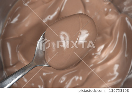 Creamy chocolate pudding on a spoon Creamy chocolate pudding on a spoon 139753108