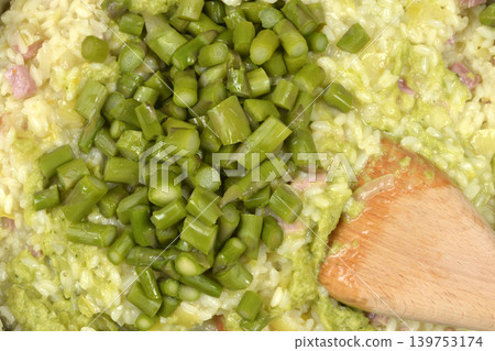 Mixing Green Asparagus into Creamy Risotto Mixing Green Asparagus into Creamy Risotto 139753174